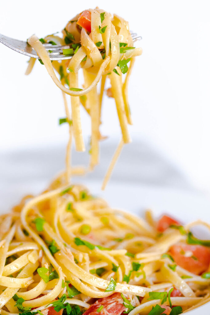 Tuna Pasta with Tomato on fork.