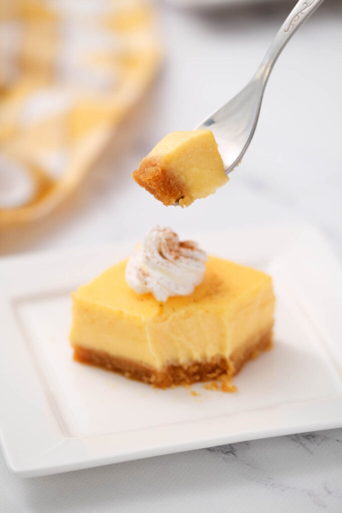 bite of pumpkin cheesecake bars.