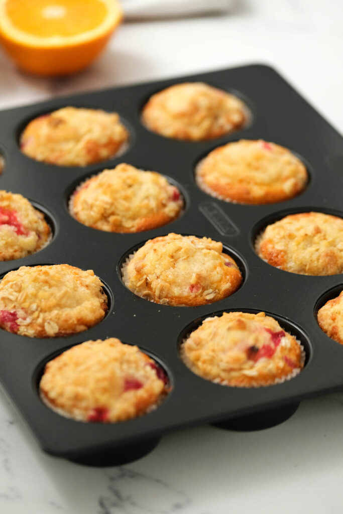 cranberry orange muffins in muffin pan.