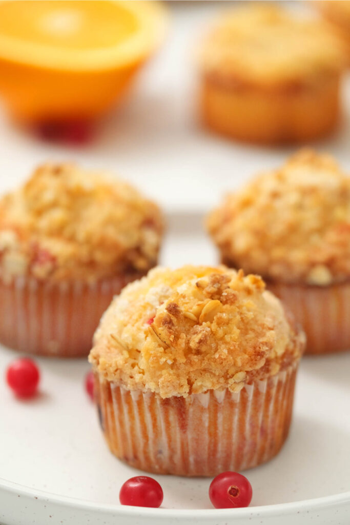 muffins on white plate with cranberries.