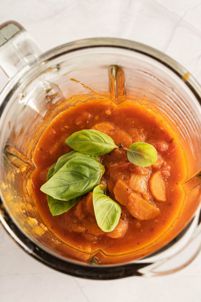 soup in blender with basil.