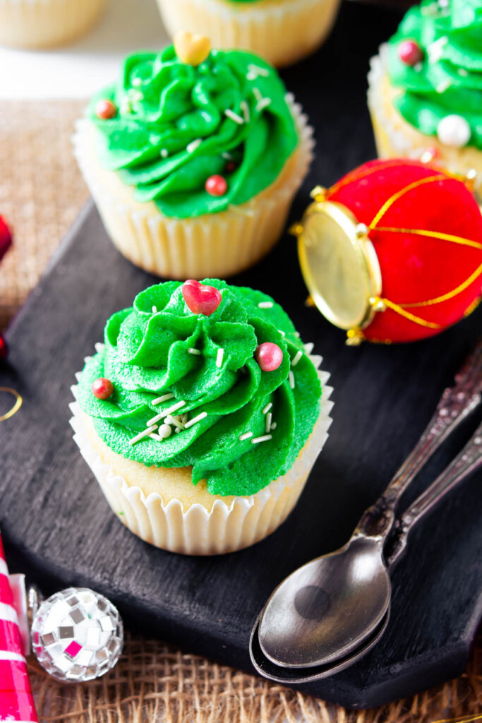 Christmas Tree Cupcakes on black background.