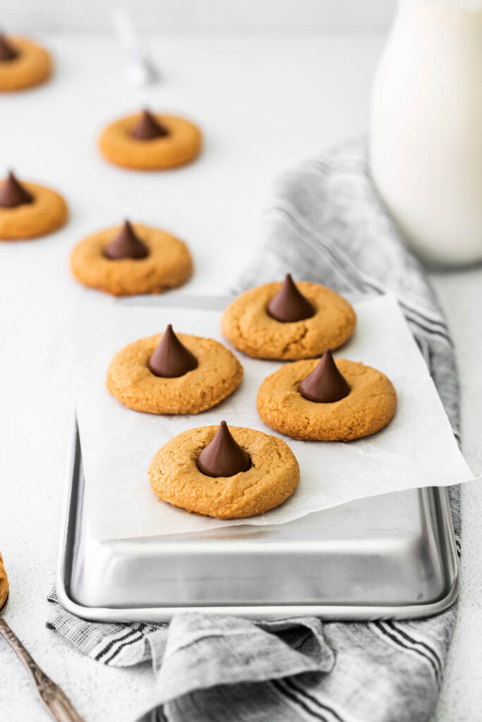 cookies with chocolate kisses on parchment paper.