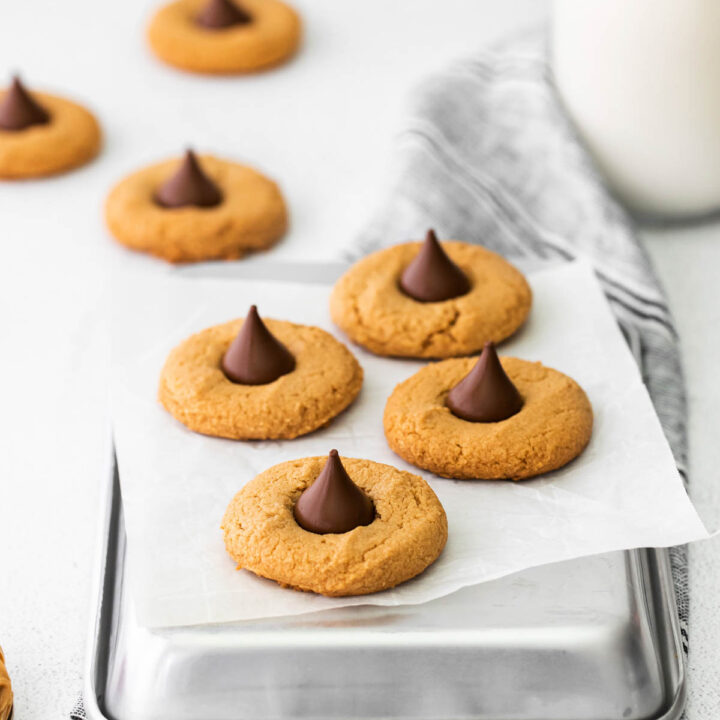 cookies with chocolate kisses on parchment paper.