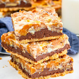 Turtle Magic Bars stacked with chocolate chips.