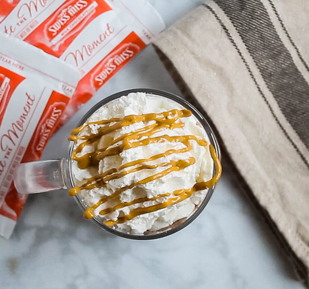 hot chocolate topped with whipped cream and peanut butter.