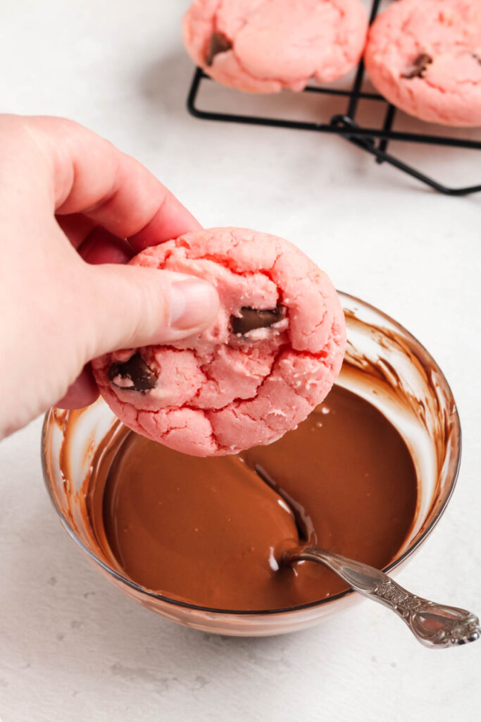 dipping cookies in chocolate.