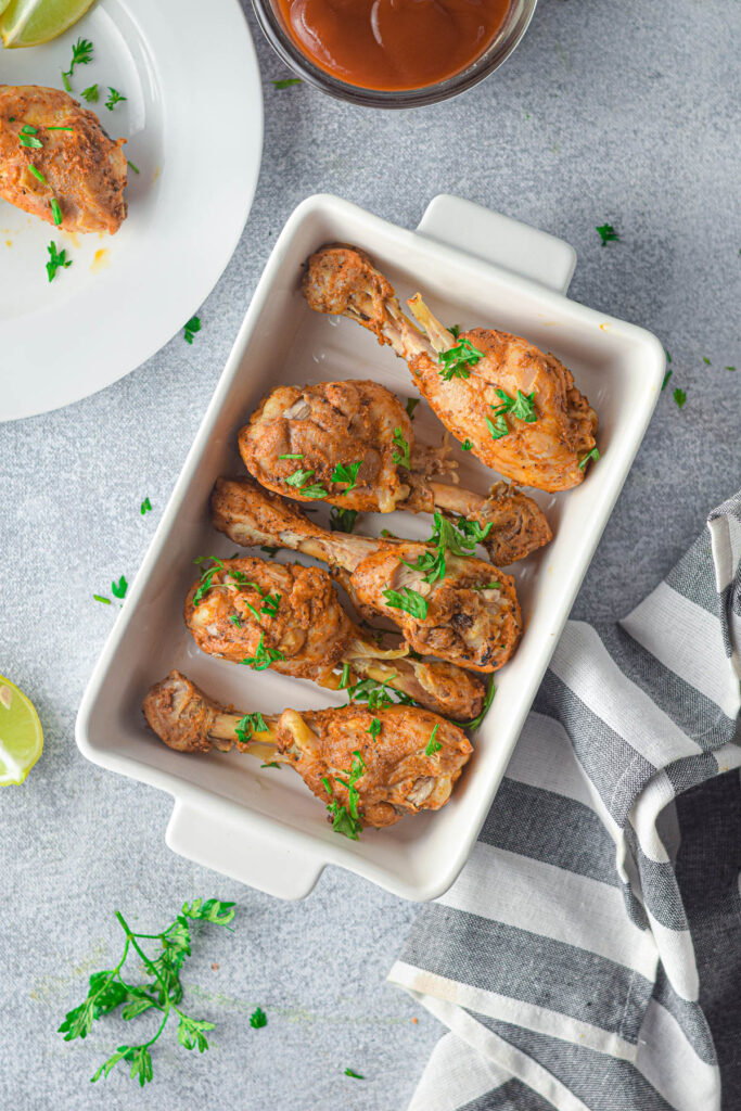 Instant Pot Chicken Drumsticks on gray background.