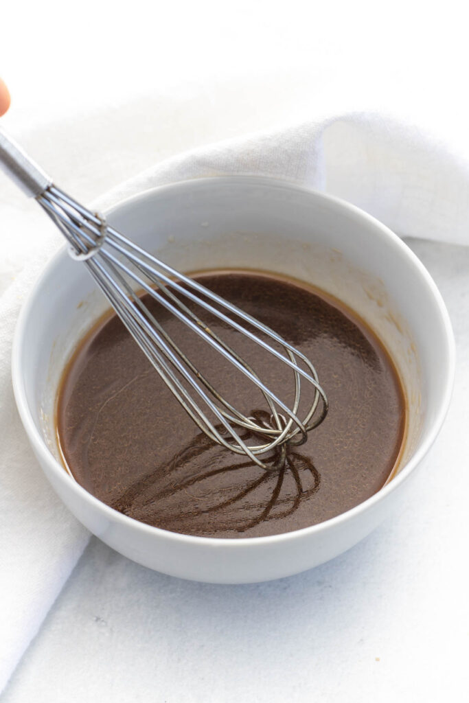 mixing stir fry sauce in bowl.