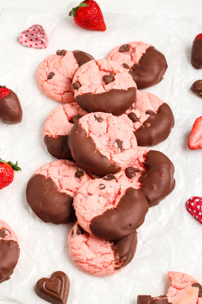 Strawberry Chocolate Cake Mix Cookies stacked on each other on white background.