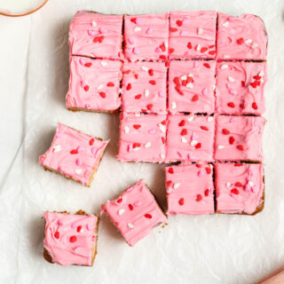 Strawberry Frosted Cookie Bars cut into squares.