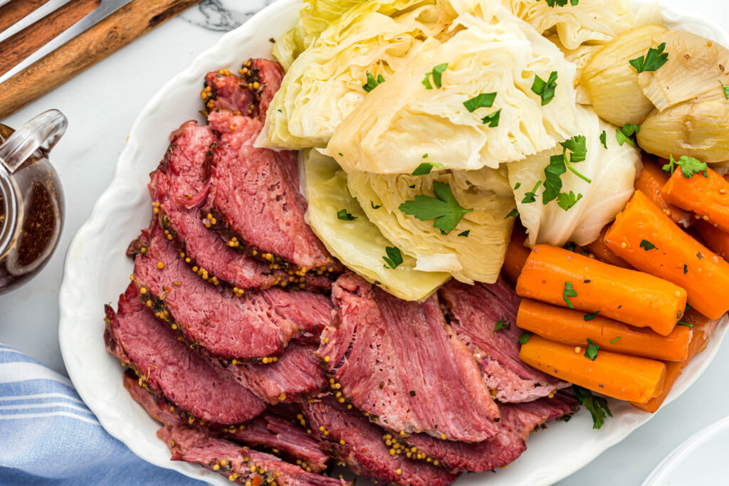 Corned beef on plate with veggies.