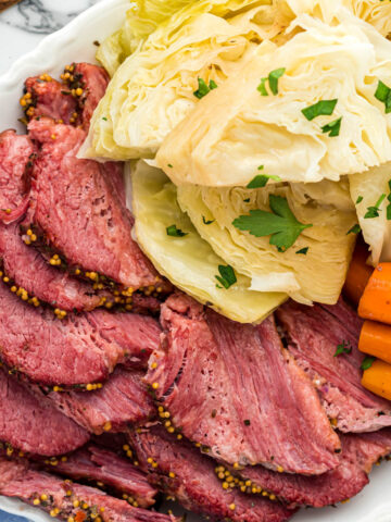 Corned beef on plate with veggies.