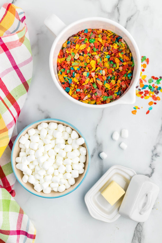 Fruity Pebbles Rice Krispie Treats ingredients in bowls.