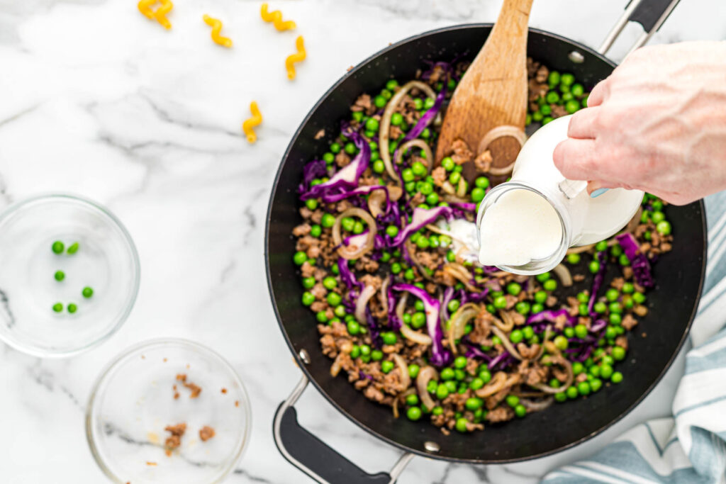 pouring cream in skillet.