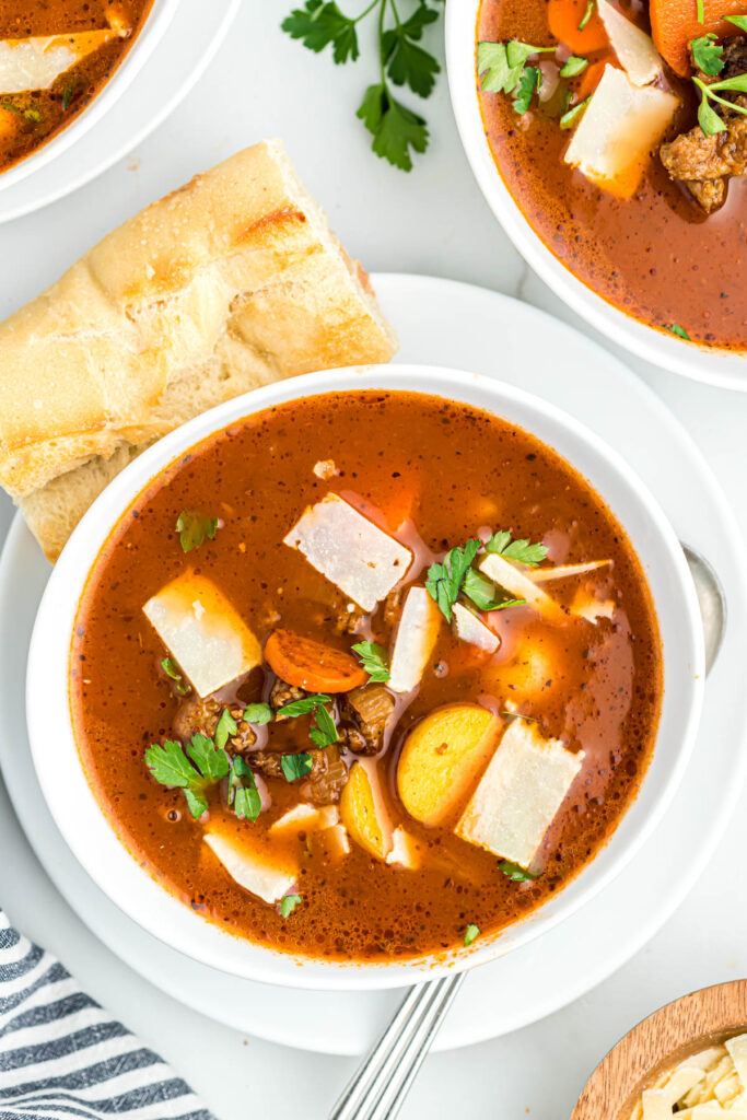 soup in white bowl on plate.