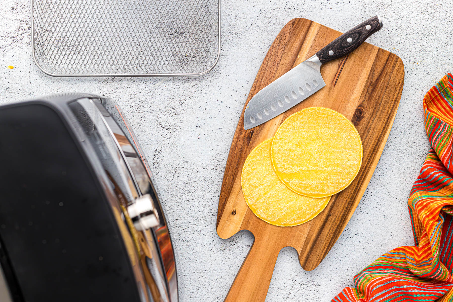 whole corn tortilla on cutting board.