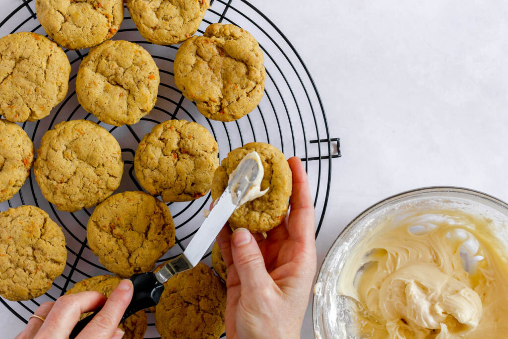 spreading frosting on cookies.