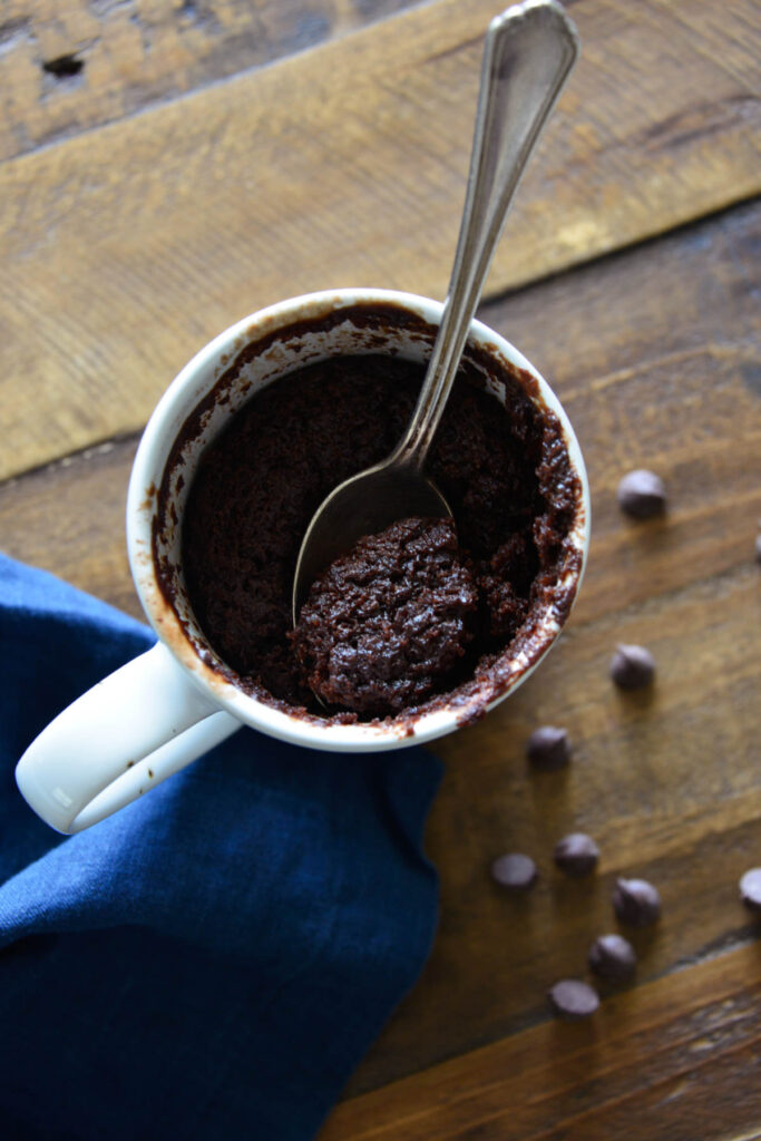 spoon in white cup with Chocolate Mug Cake.
