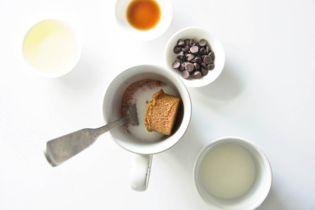 dry ingredients in white cup with fork.