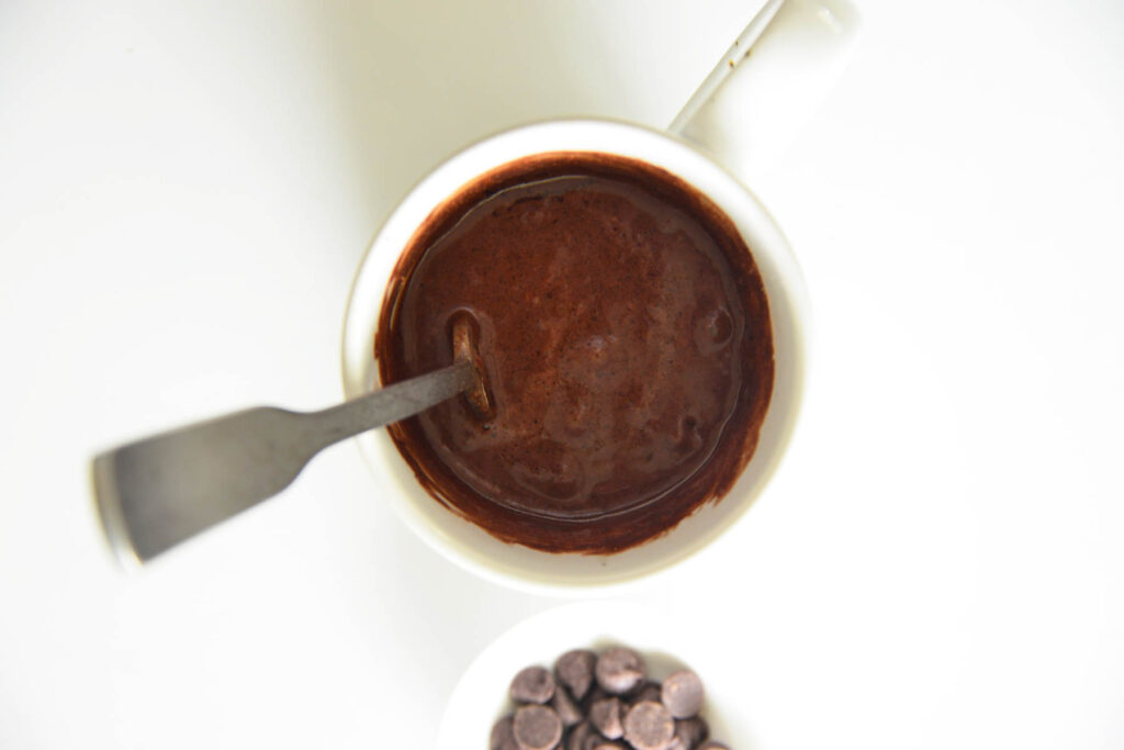 mug cake before cooked in white cup.