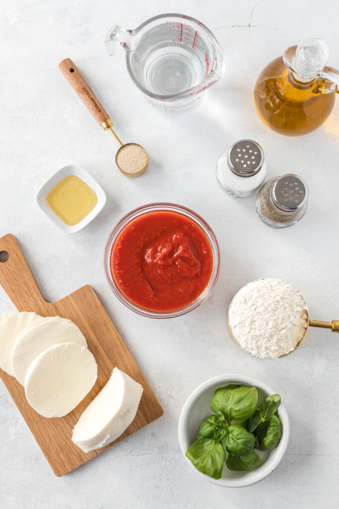 Sheet Pan Margherita Pizza Ingredients in bowls on white back ground.