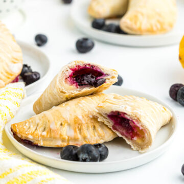 Lemon Blueberry Turnovers cut open on plate.