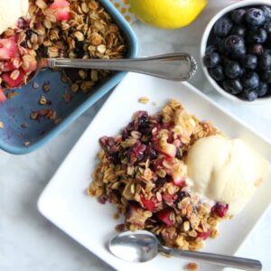 apple blueberry crisp on white plates.