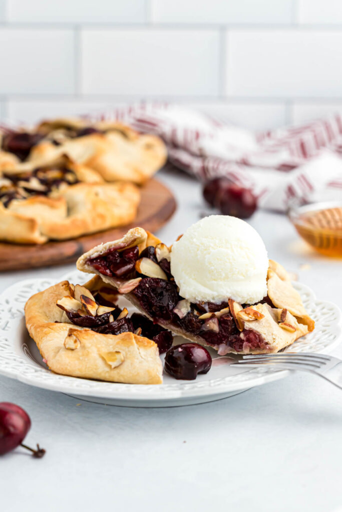 Mini Cherry Almond Galettes on white plate with ice cream.