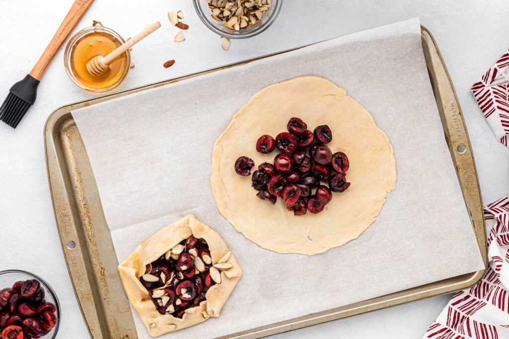 pie crust rolled out topped with cherries.