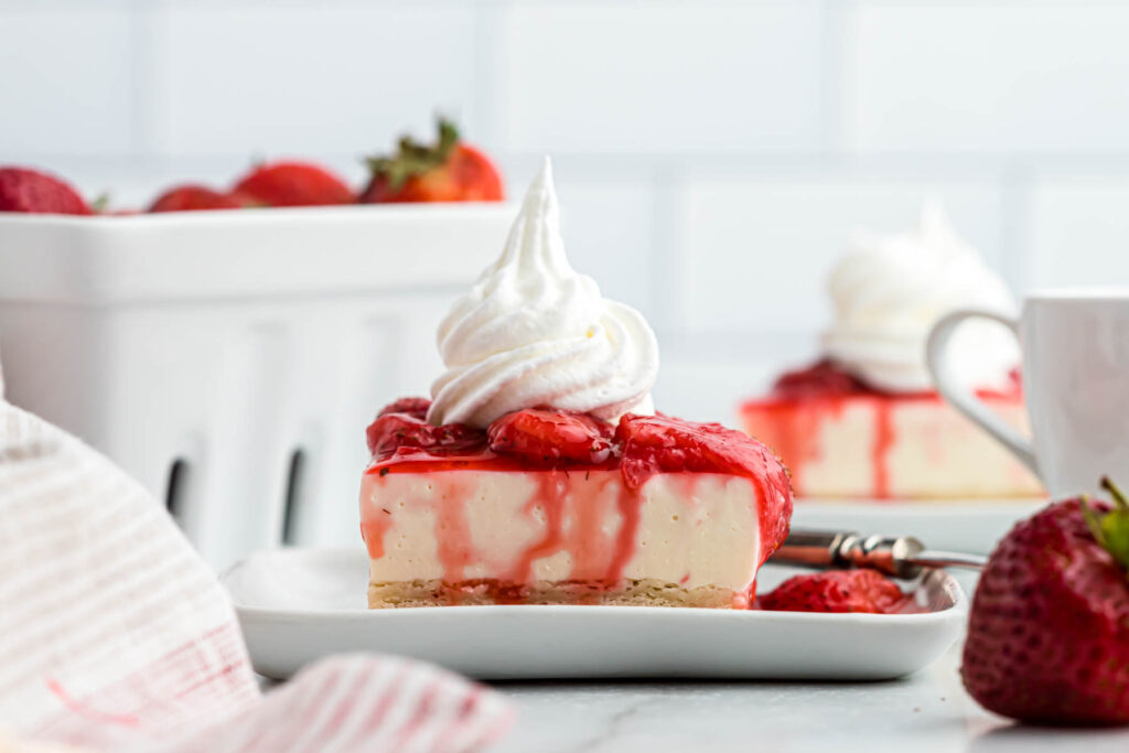 Strawberry Cheesecake Shortbread Bars on plate with strawberries.