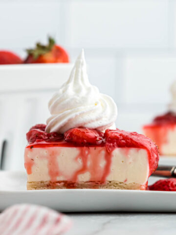 Strawberry Cheesecake Shortbread Bars on plate with strawberries.