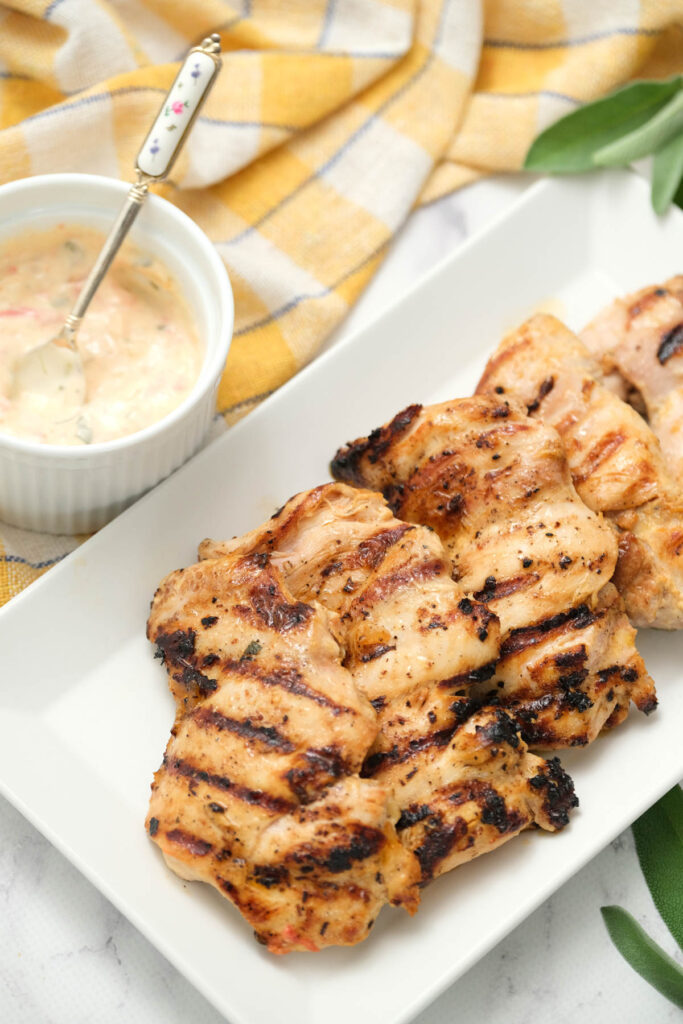 Grilled Ranch Chicken Thighs on white plate.