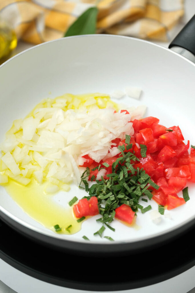 onions, oil, tomatoes, and sage in pan.