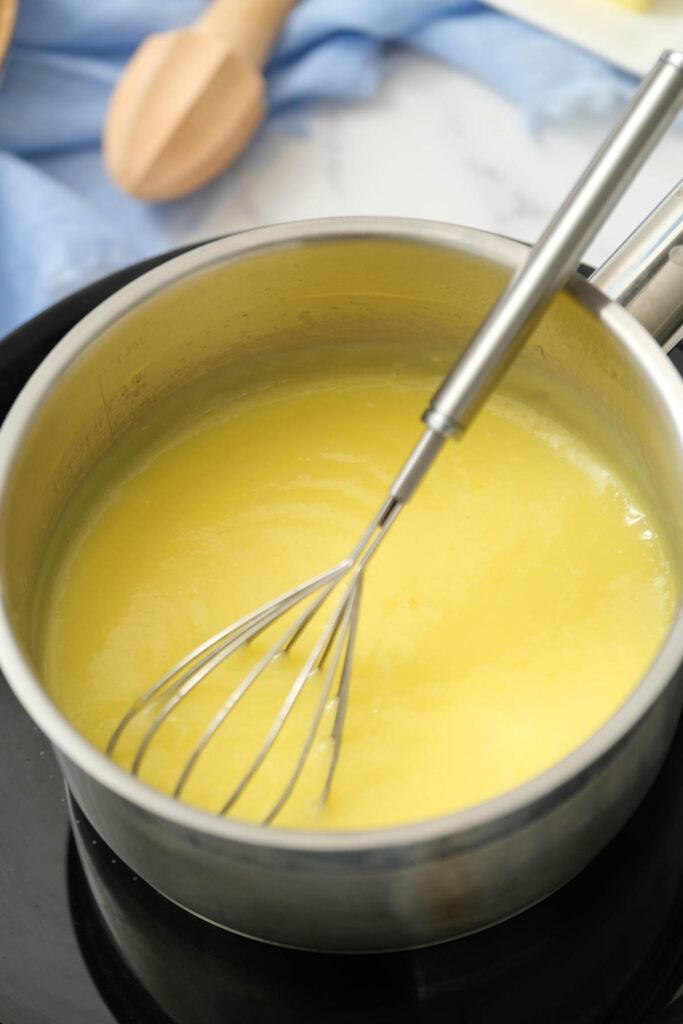 curd in pot with whisk.