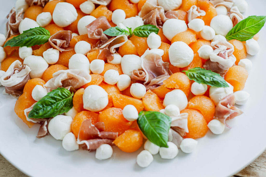 Melon Prosciutto Salad on white plate.