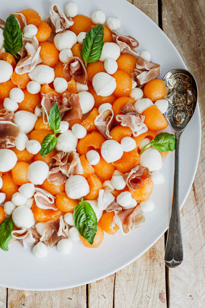 overhead view of Melon Prosciutto Salad with spoon.