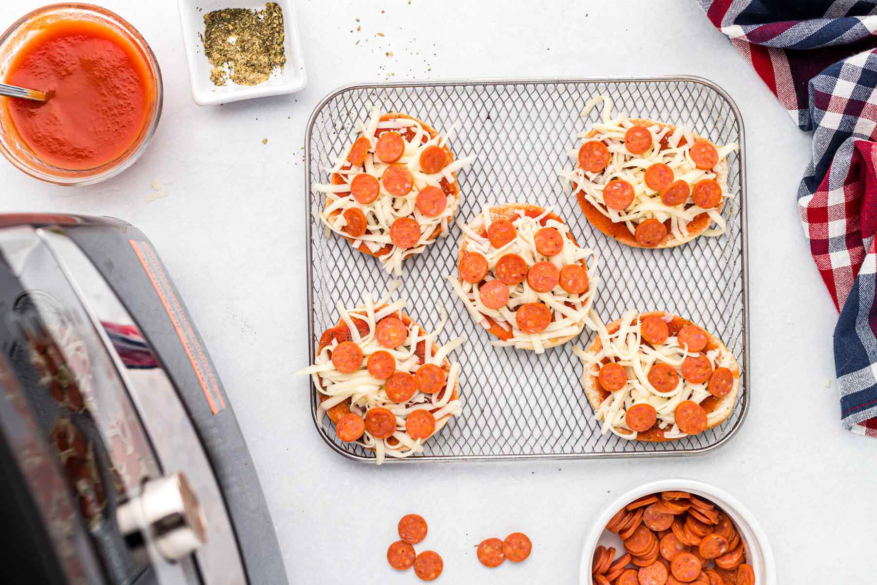uncooked bagels on tray.