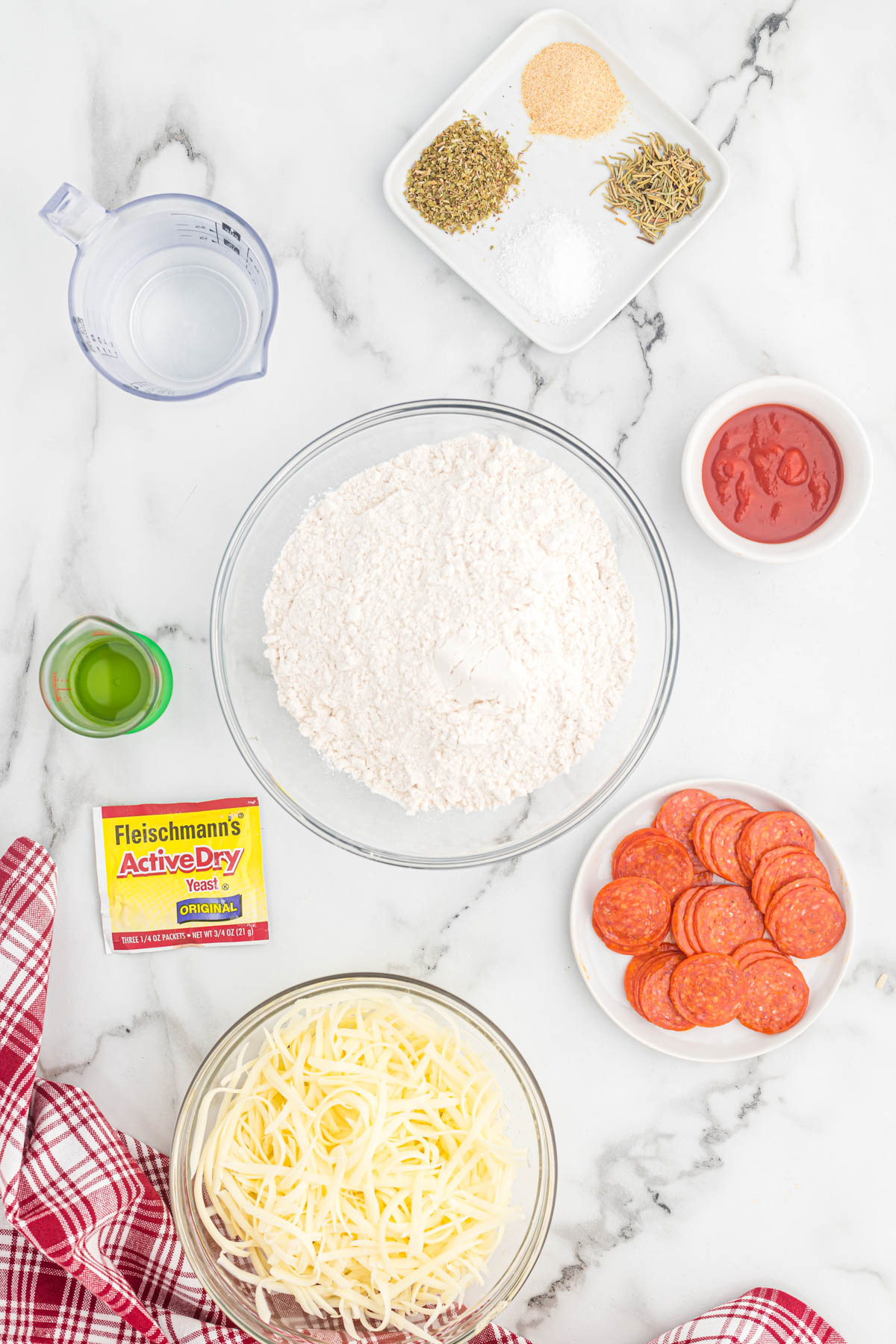 ingredients for pizza dough on white background.
