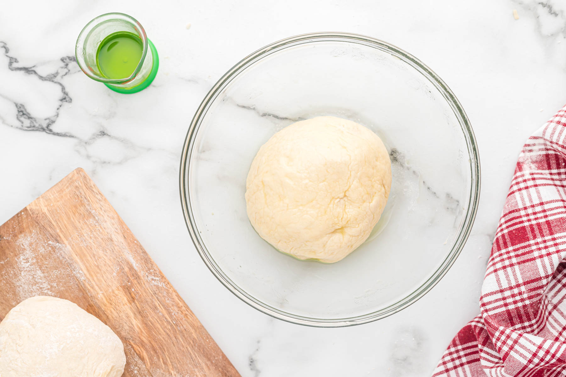 dough in oil in clear glass bowl.