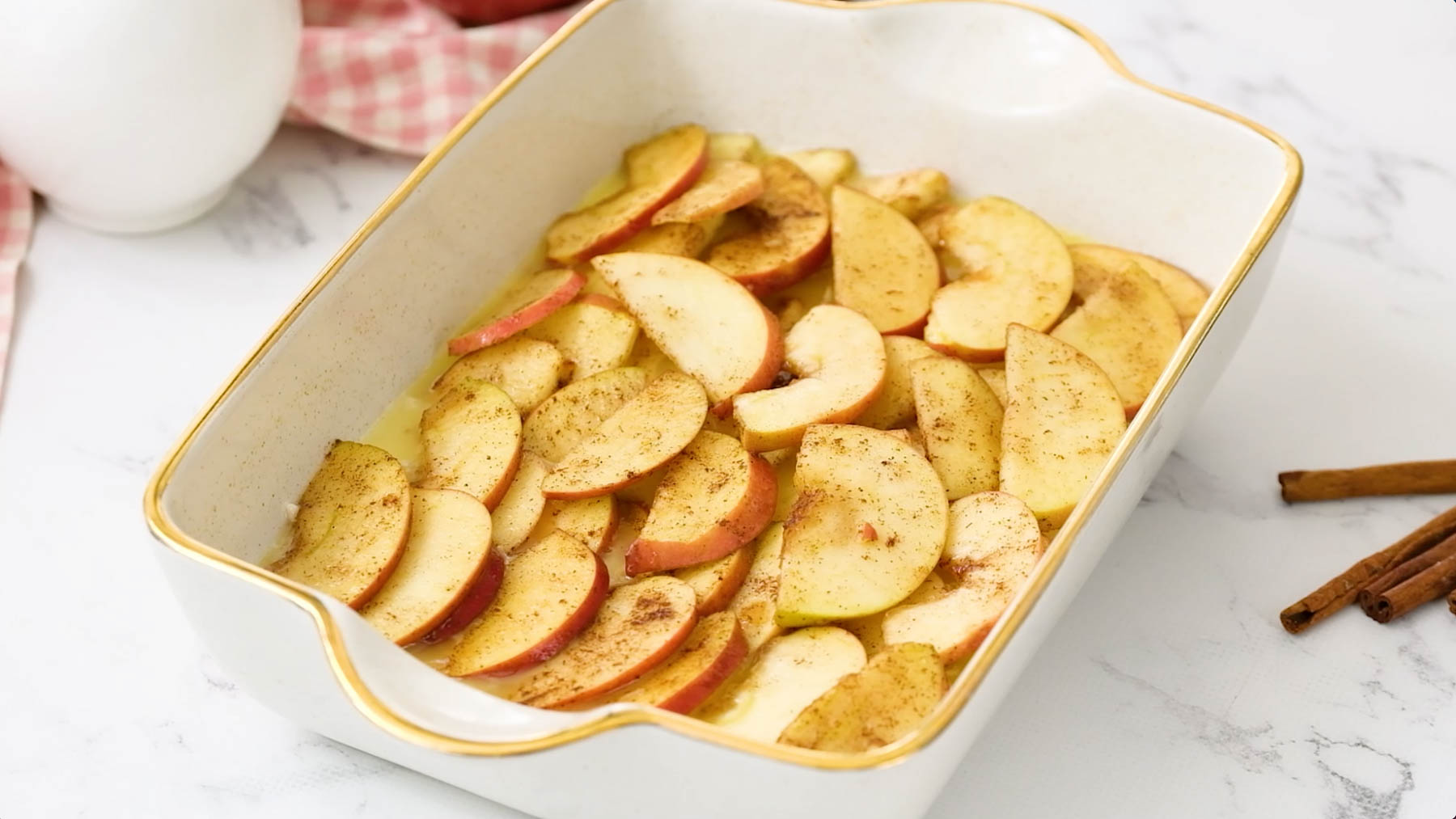 uncooked cobbler topped with apples.