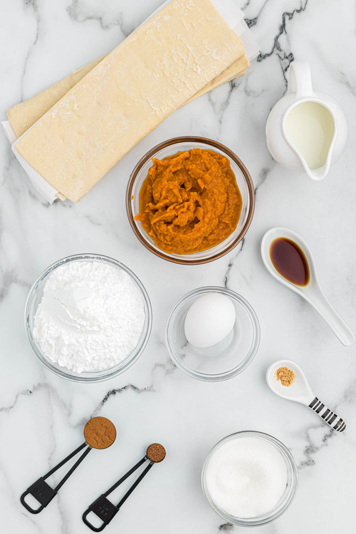 ingredients for air fryer pumpkin turnovers on white background.