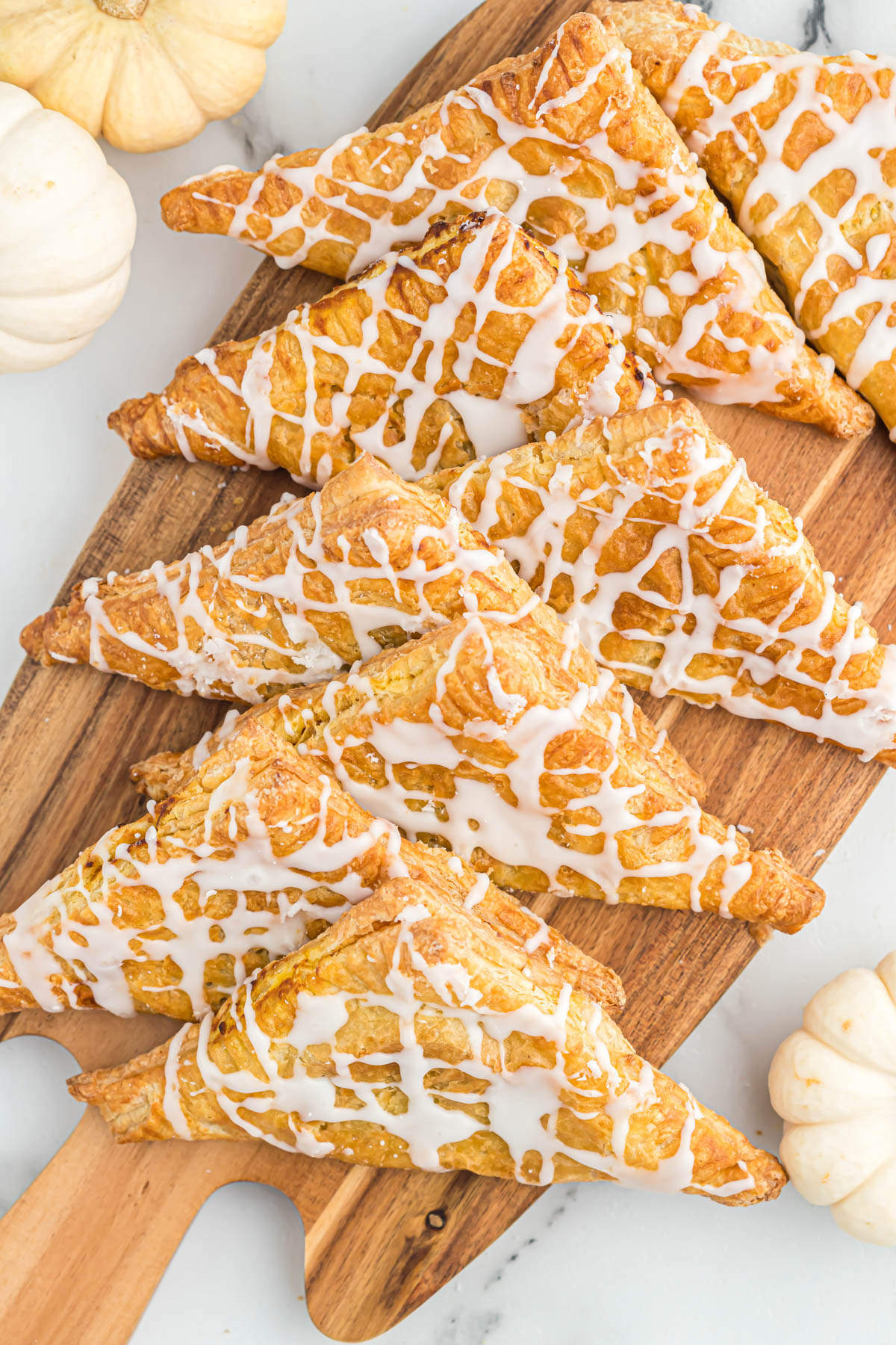 pumpkin turnovers drizzled with glaze.