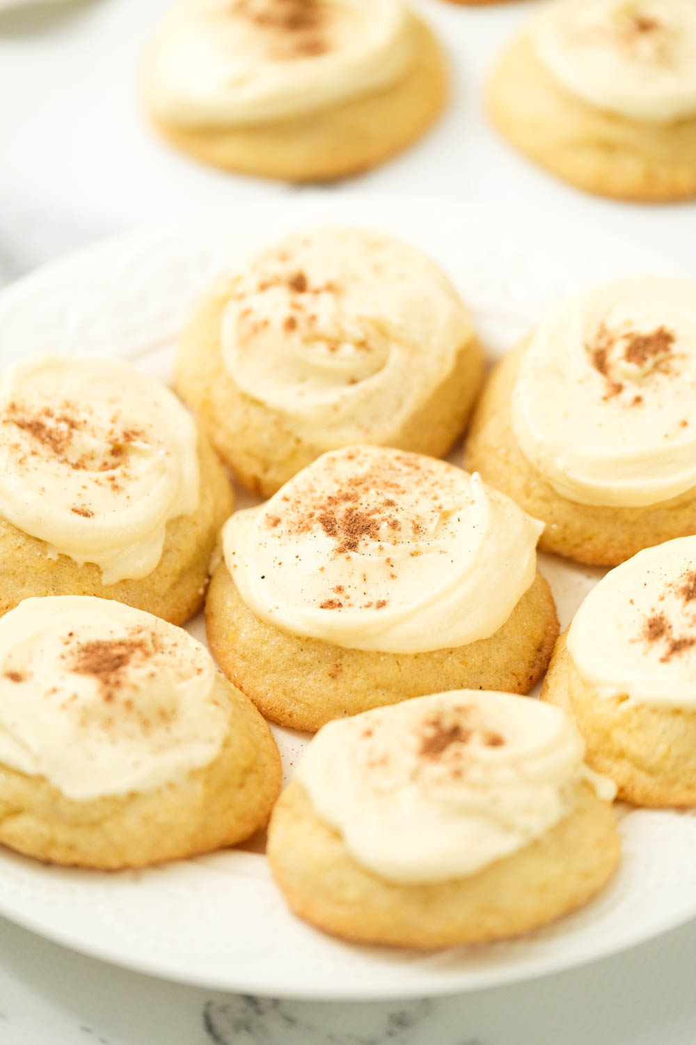 soft eggnog cookies on white plate.