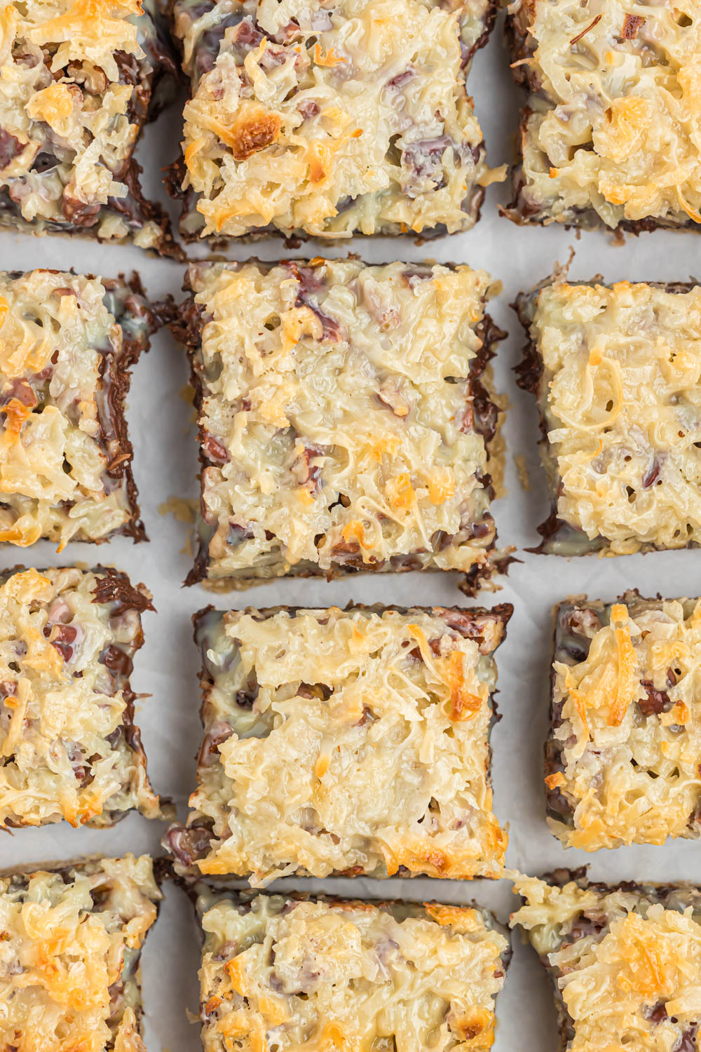 slices of Seven Layer Magic Bars on white background.