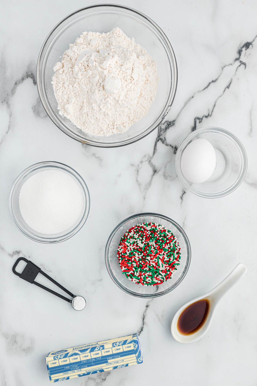 ingredients for vanilla cookies in glass bowls.