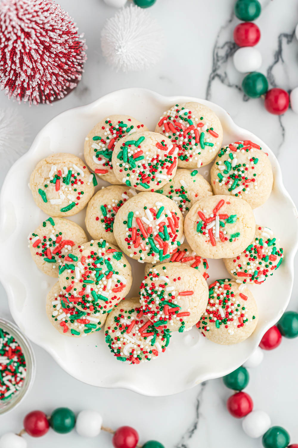 vanilla cookies stacked on white plate.