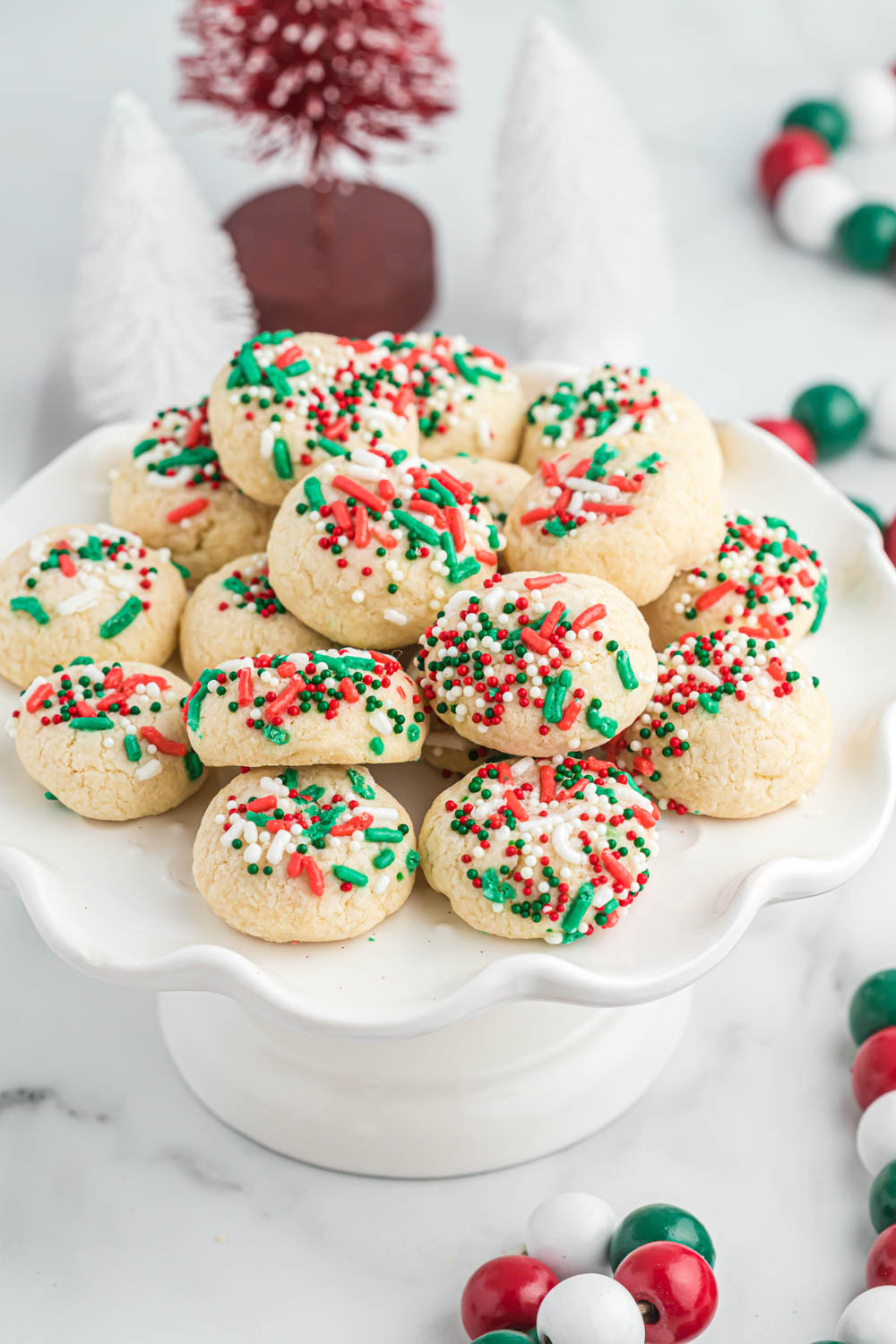 Vanilla Christmas Cookies stacked on white plate.