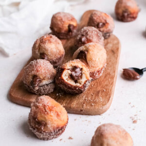 Close-up of Nutella donut hole with bite take out of center.