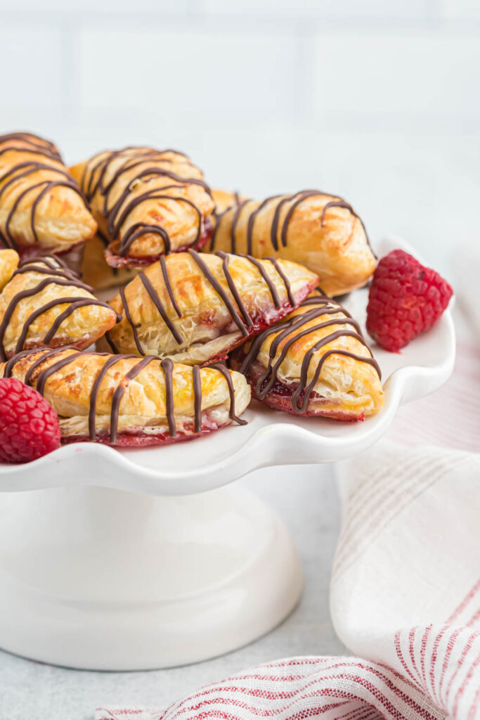 Raspberry Chocolate Hand Pies on white platter.